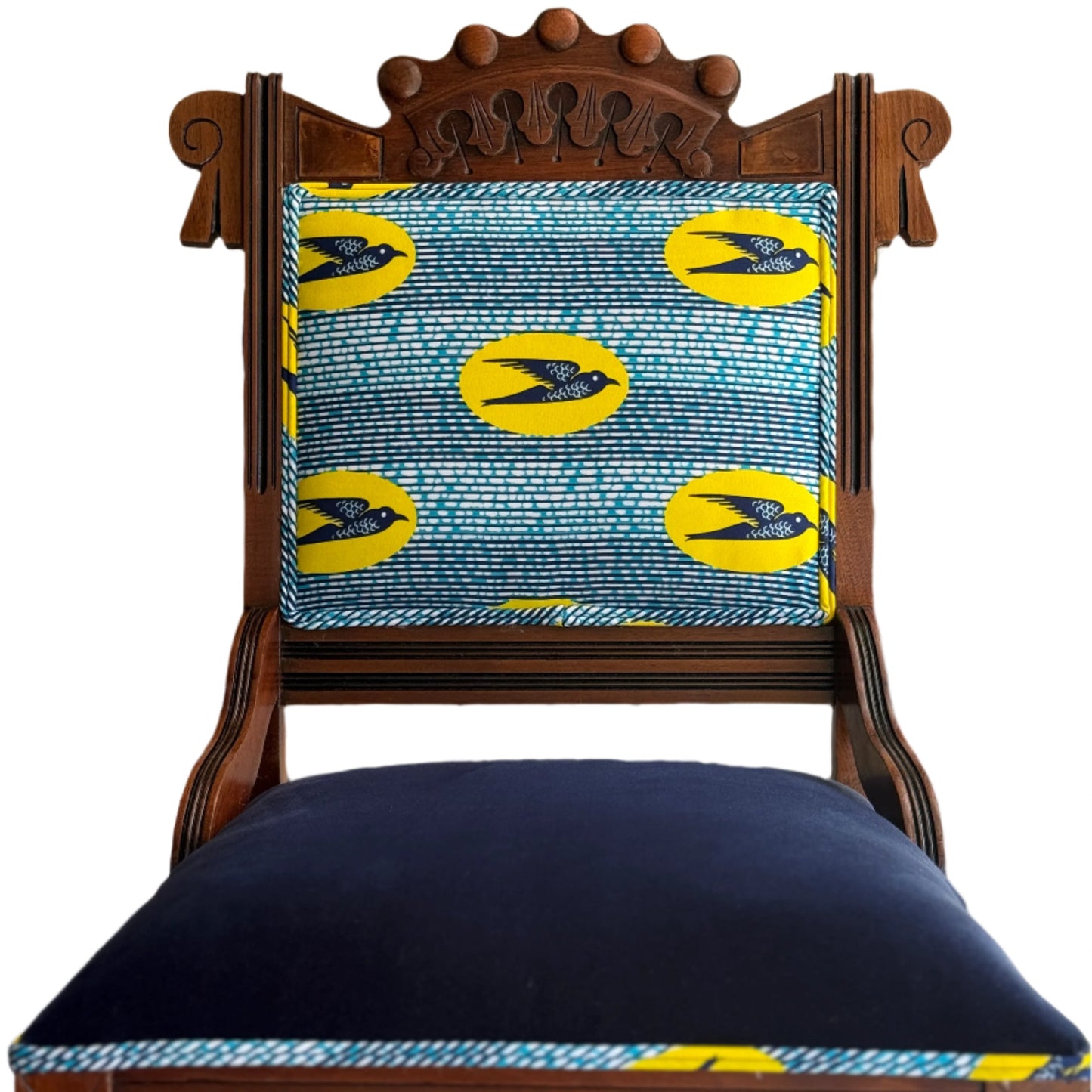 Wooden chair with a blue cushion and yellow Speedbird African wax patterned backrest